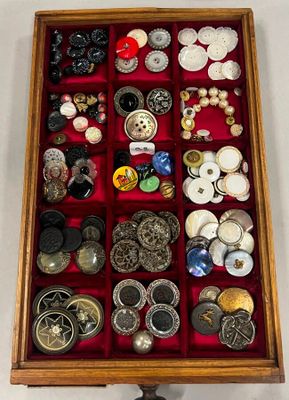 une boîte en bois remplie d'une multitude de boutons de toutes sortes