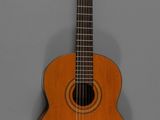 un gros plan d'une guitare acoustique sur fond gris