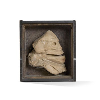 a stone sculpture of a fish in a wooden box
