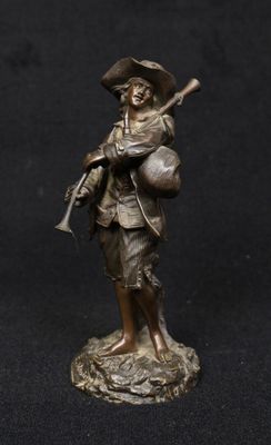 bronze figurine of a man with a gun and a hat