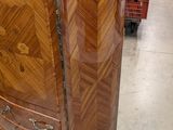 a wooden dresser with a marble top in a store