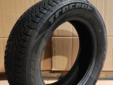 tire on the floor in front of a cardboard box with a cardboard box in the background