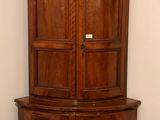 a corner cabinet in the corner of a room