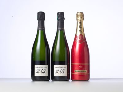 three bottles of champagne are lined up on a table