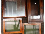 two framed pictures of a cat sitting on a window sill