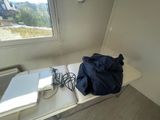 a table with two laptops and a bag on it