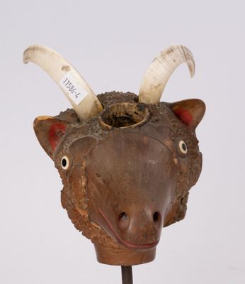 a wooden sculpture of a cow with horns on it ' s head