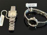 two watches and a bracelet sitting on a table