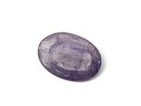 a close up of a purple stone on a white surface