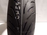 a close up of a motorcycle tire on a white surface