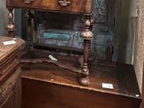 a wooden desk with a mirror on top of it in a room