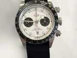 rolex watch with black strap and white dial on white background