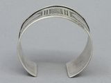 a close up of a silver cuff bracelet with the word ' i love you ' written on it