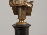 a statue of a man with a beard on top of a pedestal