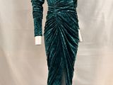 a green velvet dress with long sleeves and a v neckline