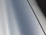 a close up of a car ' s door handle with a small sticker on it