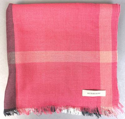 a pink scarf with a check pattern on it