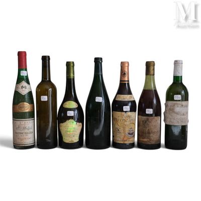 several bottles of wine are lined up in a row on a white surface