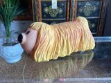 a glass table with a vase on it and a lion head on it