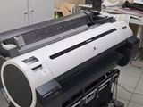 a large printer that is sitting on a stand in a room