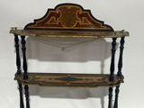an antique wooden shelf with three shelves on top of it