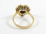 a close up of a gold ring with a blue stone in the center