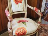 a chair that has a flower on the back of it