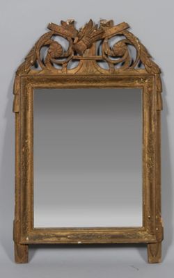an image of a gold framed mirror with a bird design on it