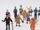 many figurines of people standing together in a circle