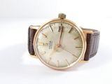 a watch that is sitting on a white surface