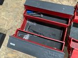 a red tool box sitting on top of a wooden floor