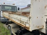 a white truck that is sitting in the grass