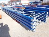 a large pile of blue steel beams in the middle of a parking lot