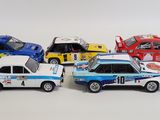 several toy cars are lined up in a row on a white surface
