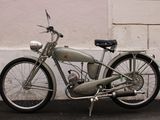 a old motorcycle parked on the side of the street