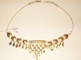 a close up of a necklace on a table with a price tag