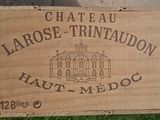 a wooden box with a sign on it that says chateau larose trinidadon