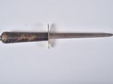 a close up of a knife on a table with a white background