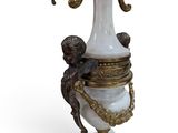 a white and gold vase with an octopus on it
