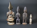 three wooden figurines sitting next to each other on a black surface