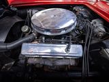 a red car engine with a chrome cover on it ' s hood