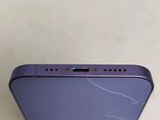 the back of a purple iphone with a cracked screen