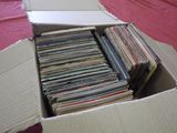 a cardboard box full of records on a table