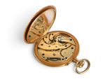a gold pocket watch with a chain on a white surface