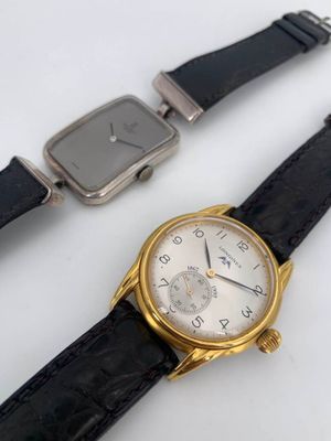 two watches sitting next to each other on a table