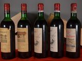 several bottles of wine are lined up on a table