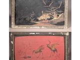 two framed paintings of birds and flowers on a red background