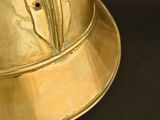 a gold helmet that is sitting on a table
