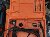 an orange tool box with tools in it sitting on the floor