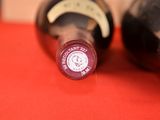 two bottles of wine sitting on a red table
